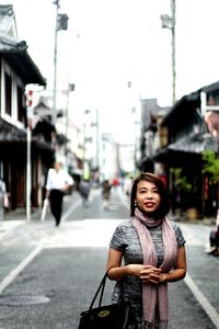 Portrait of woman standing on city street