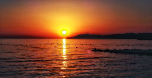 Scenic view of sea against romantic sky at sunset