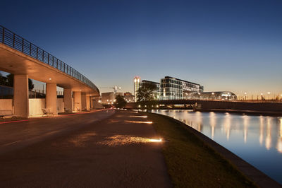 Bridge in city against clear sky