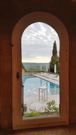 Sea seen through arch window of building