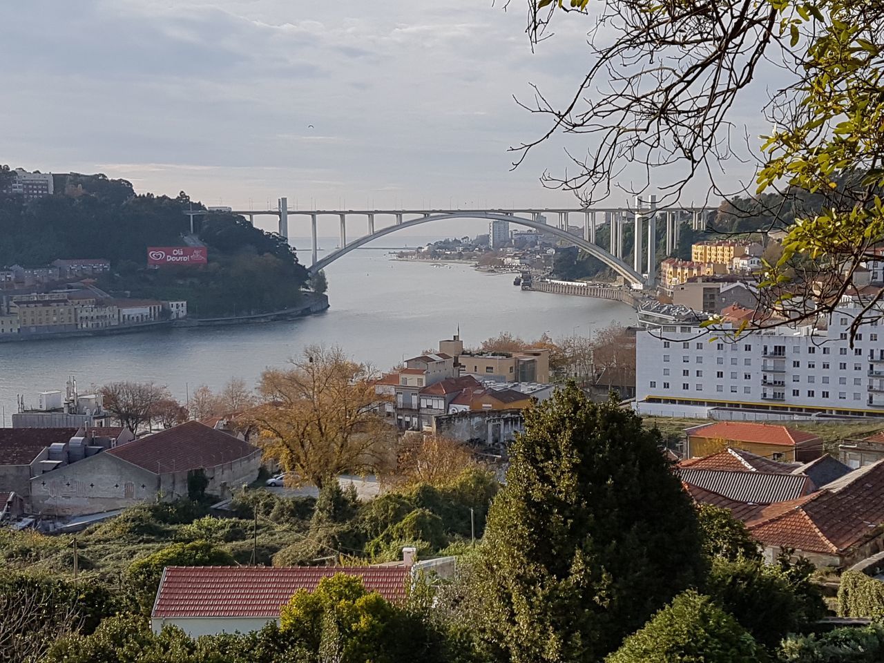 HIGH ANGLE VIEW OF BRIDGE OVER RIVER AND BUILDINGS IN CITY