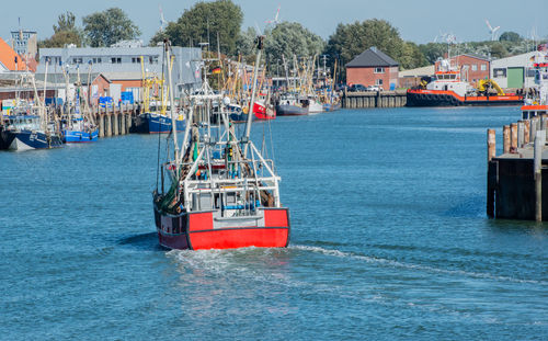 Nautical vessel on sea against sky in city