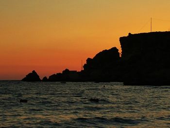 Scenic view of sea against orange sky