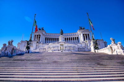 Low angle view of altar of the fatherland against clear blue sky