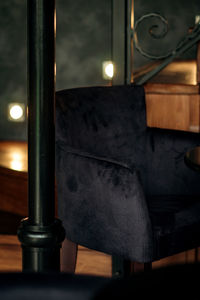 Close-up of illuminated lamp on table at night