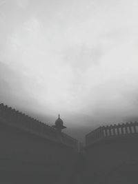 Low angle view of built structure against cloudy sky