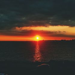 Scenic view of sea against romantic sky at sunset