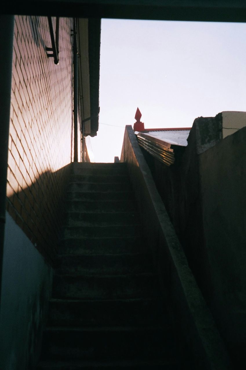 architecture, built structure, the way forward, steps, steps and staircases, staircase, railing, transfer print, building exterior, clear sky, auto post production filter, low angle view, sunlight, diminishing perspective, wall - building feature, stairs, sky, narrow, day, walking