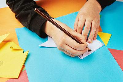 Boy making paper dog origami