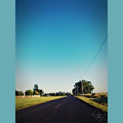 Road against clear blue sky