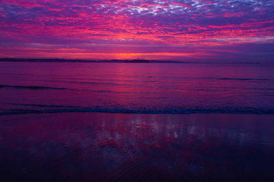 Scenic view of sea against romantic sky at sunrise