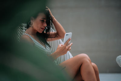 Midsection of woman using mobile phone