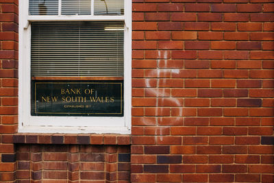 Text on brick wall of building