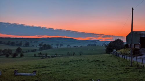 Scenic view of field against sky during sunset
