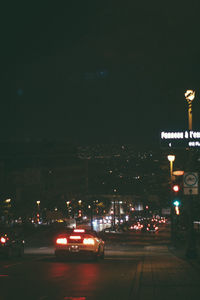 View of illuminated road at night