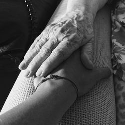 Cropped image of mother holding daughter hand