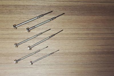 High angle view of nails on wooden table