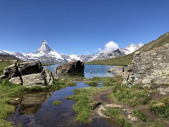 Scenic view of snowcapped mountains against clear sky