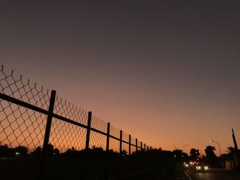 Silhouette of road against sky during sunset