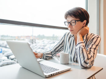 Business woman works with laptop in co-working center. workplace for freelancers in business center.