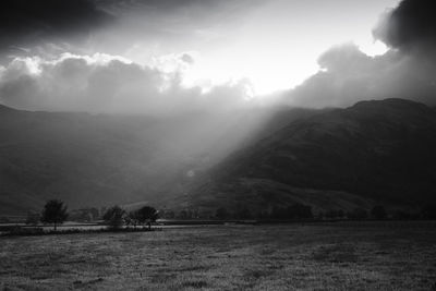 Scenic view of landscape against cloudy sky