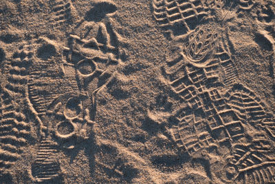 High angle view of footprints on sand