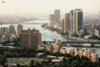 High angle view of buildings by sea against sky