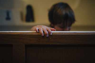 Boy in wooden bathtub at home