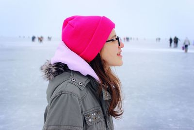 Girl standing on snow against sky