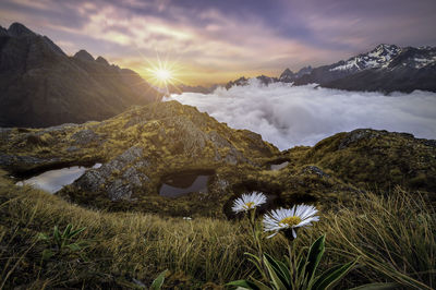 Scenic view of sea and mountains against sky