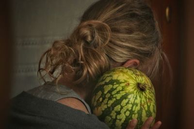 Close-up portrait of woman holding fruit
