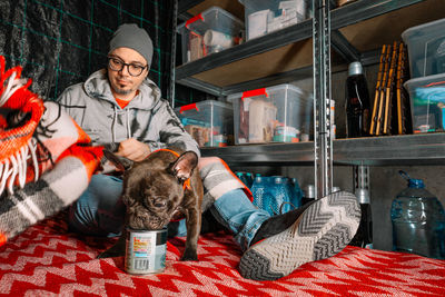 Man and french bulldog dog in underground emergency shelter