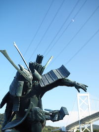 Low angle view of crane against clear sky