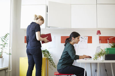 Mid adult businesswomen working in office