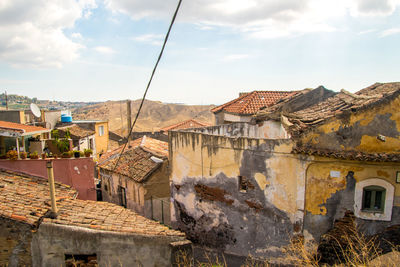 Buildings in town against sky