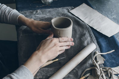 Cropped image of hands holding cup