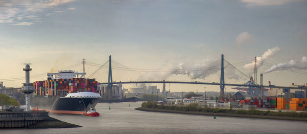 Boats in river against sky