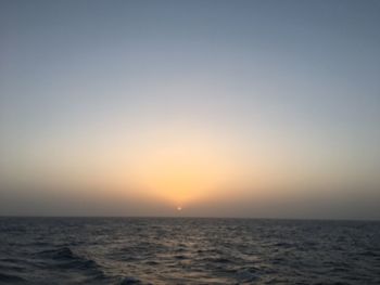 Scenic view of sea against clear sky during sunset