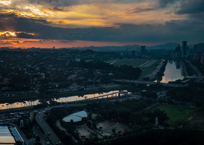 High angle view of bridge and cityscape against sky during sunset