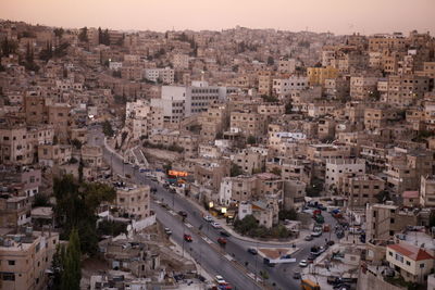 Aerial view of buildings in town during sunset