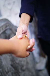 Cropped image of couple holding hands 