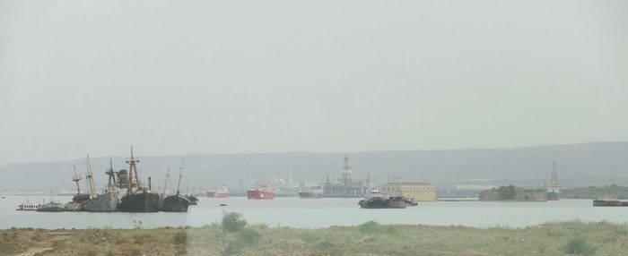 Boats in sea against sky