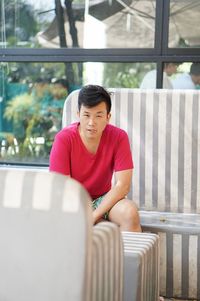 Portrait of young man sitting at restaurant