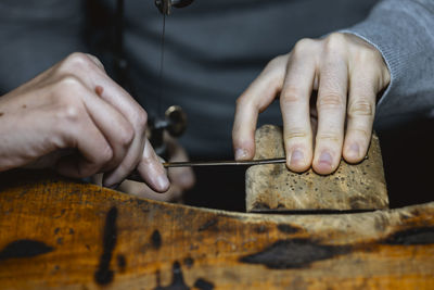 Midsection of man working at workshop