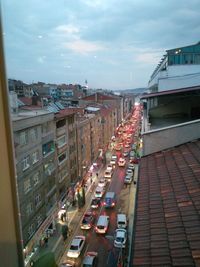 Cars on road in city against sky