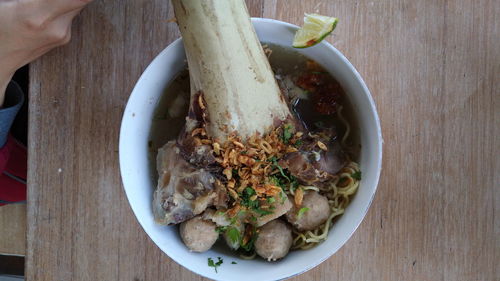 Close-up of hand holding food in plate