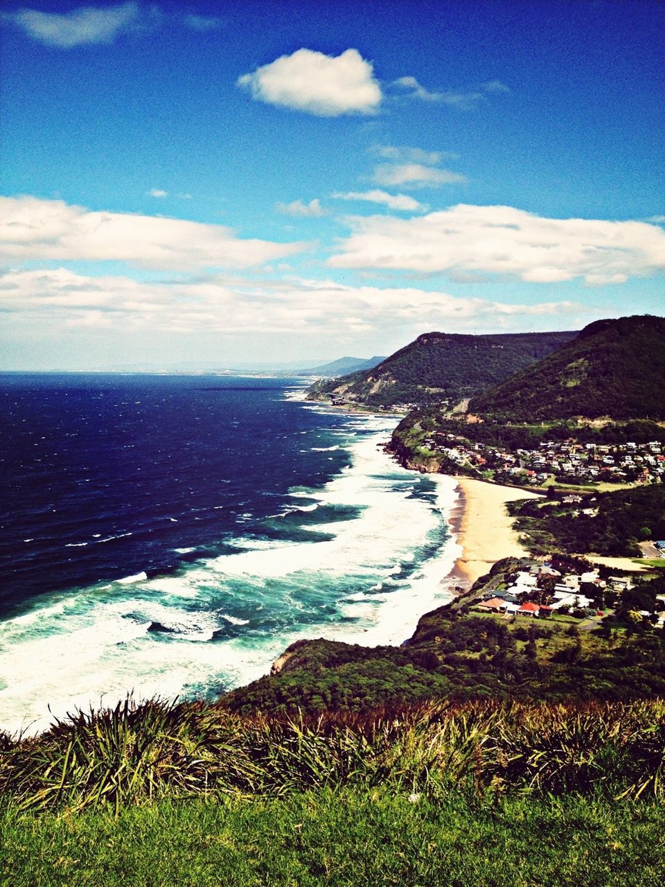 sea, water, sky, scenics, tranquil scene, beauty in nature, horizon over water, tranquility, blue, coastline, nature, mountain, beach, grass, cloud - sky, idyllic, shore, high angle view, cloud, landscape