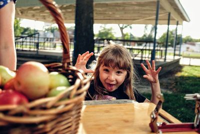 Portrait of happy girl with fruits on cutting board