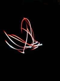 Light trails against black background