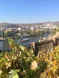 High angle view of river and buildings against clear sky